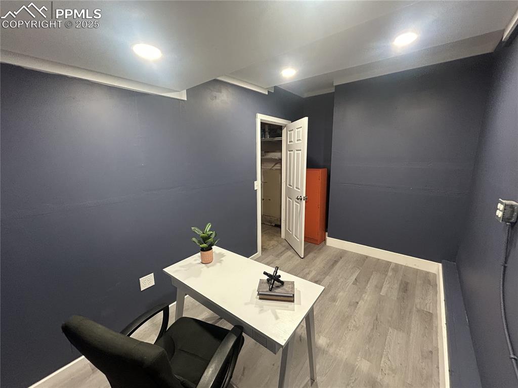 Image 32 of 46: Home office featuring light wood-type flooring and recessed lighting