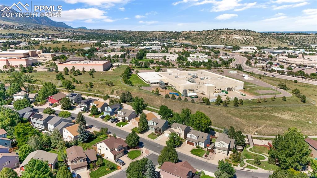 Image 36 of 46: View of property location with mountains and nearby suburban area