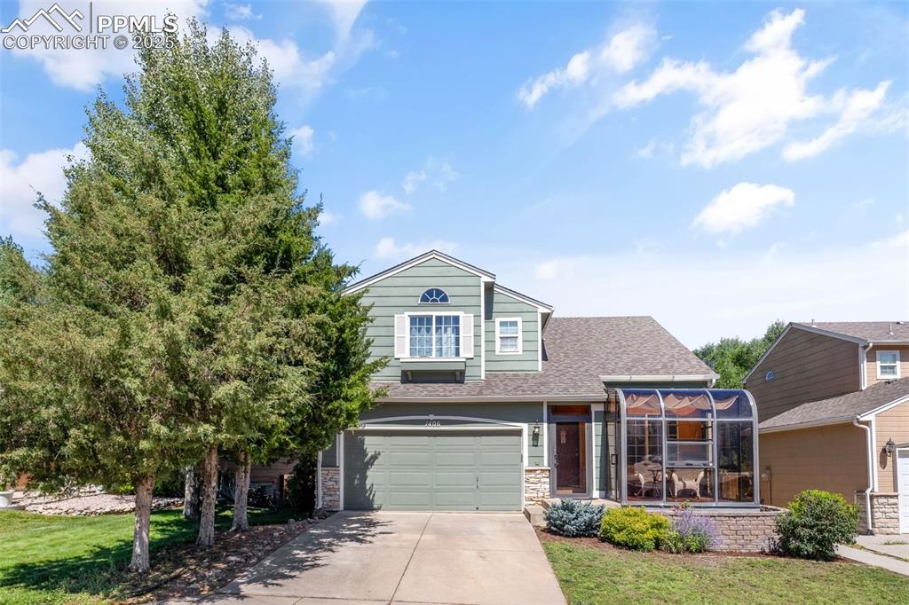 Image 42 of 46: View of front of house featuring a front lawn, concrete driveway, an attach