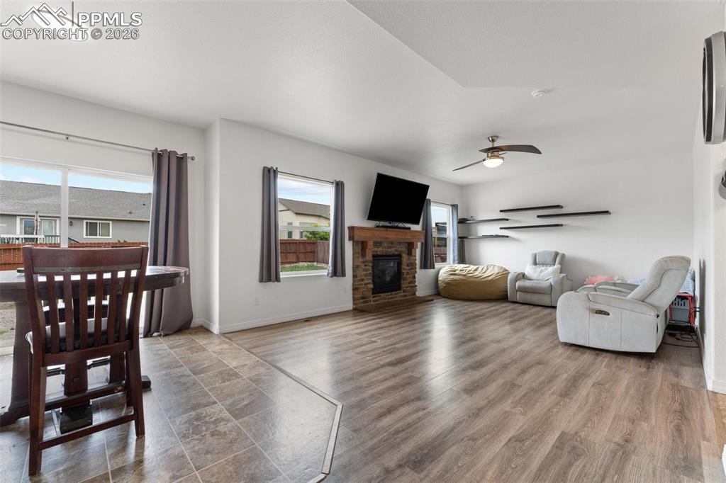 Image 13 of 50: Dining Area with Walk-out and Main Level Family Room with Gas Fireplace