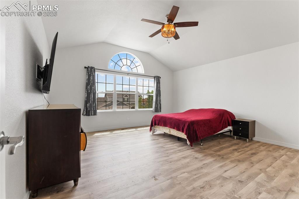 Image 19 of 50: Primary Bedroom with Vaulted Ceiling, French Doors for En-suite and Walk-In
