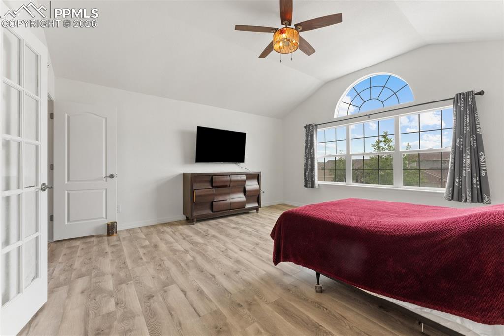 Image 21 of 50: Primary Bedroom with Vaulted Ceiling, French Doors for En-suite and Walk-In