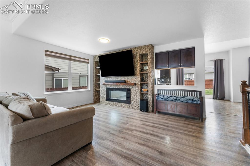 Image 8 of 50: Main Level Living Room with Electric Fireplace and Built-In Shelving