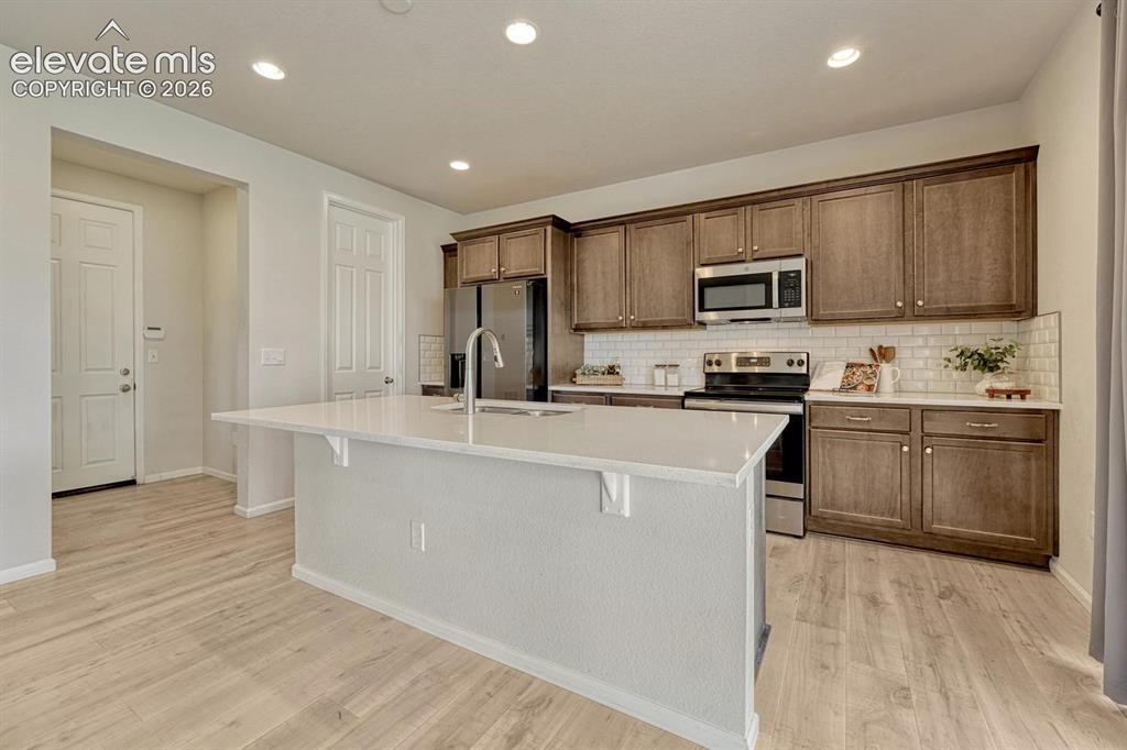Image 17 of 50: The Dining Area is located off the Kitchen with a slider to the covered bac