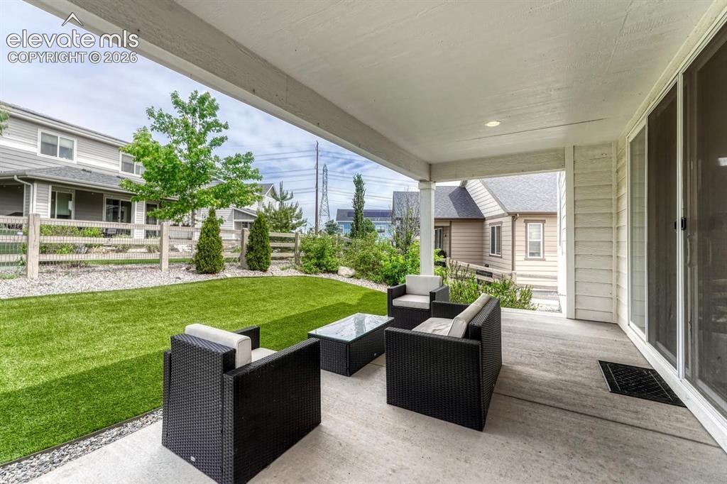 Image 23 of 50: Tranquil backyard with covered patio.