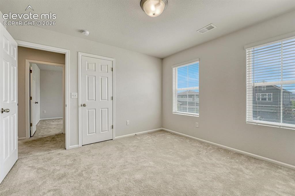 Image 40 of 50: Upper Level Bedroom #3 offers a walk in closet.