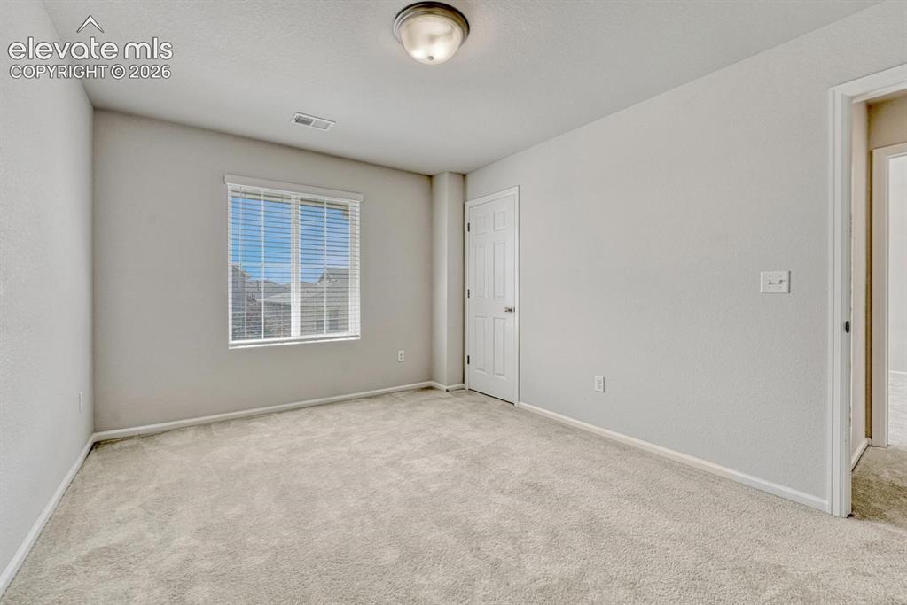 Image 42 of 50: Upper Level Bedroom #4 has neutral carpet.