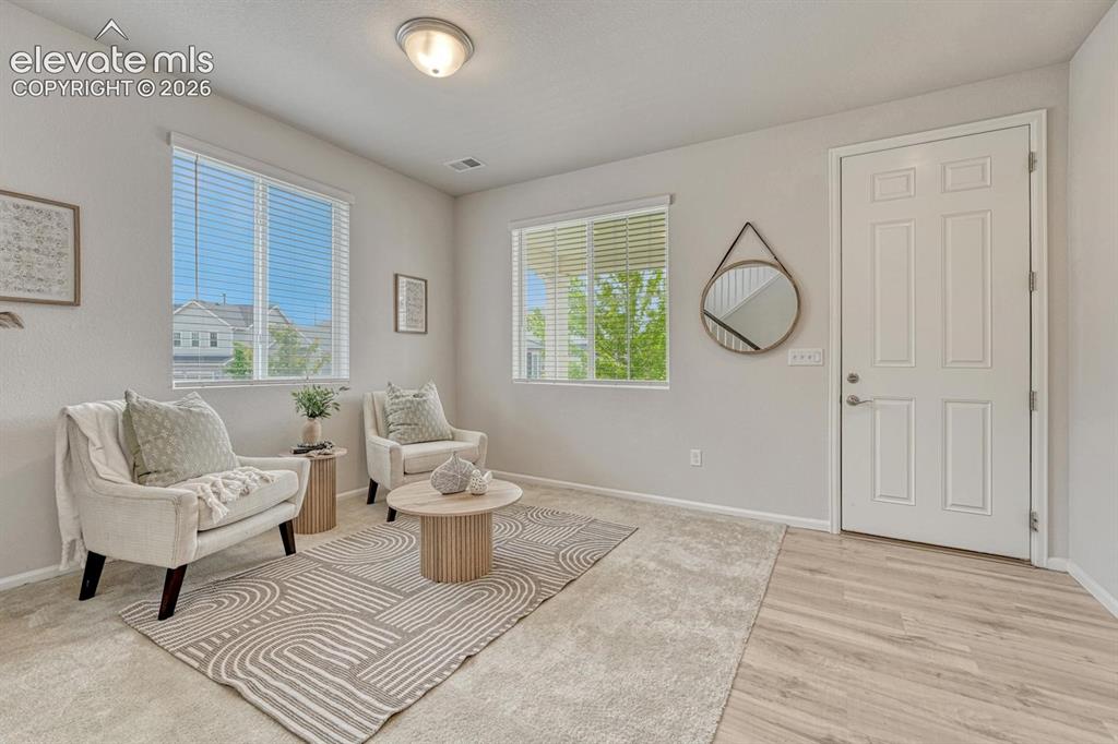 Image 7 of 50: Formal Living Room with neutral carpet and front yard views.