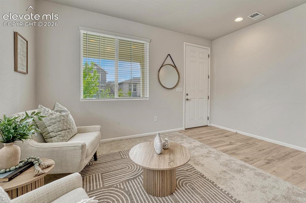 Image 9 of 50: The Front Entry has beautiful LVP flooring that leads into the Family Room,