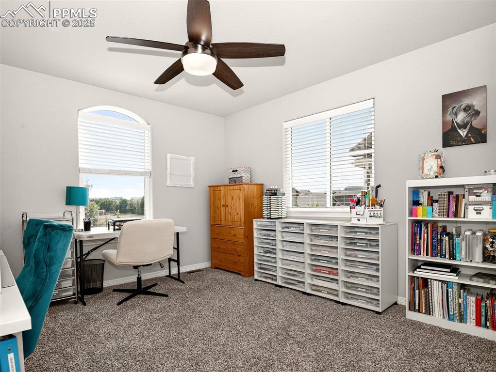 Image 28 of 48: Upper-level secondary bedroom (currently used as a craft room).