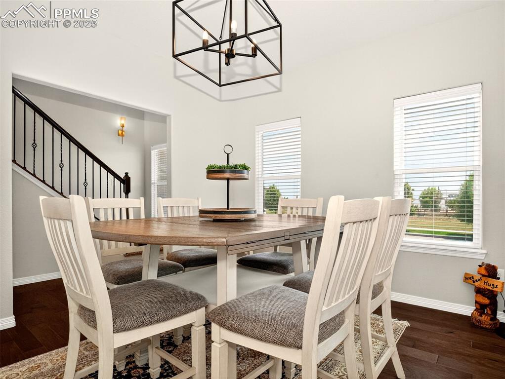 Image 4 of 48: Stair handrail is in view as you look out from the separate dining room.