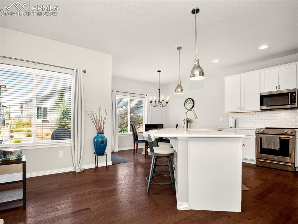 Image 8 of 48: Amazing with island, stainless steel appliances, quartz countertops, tile b