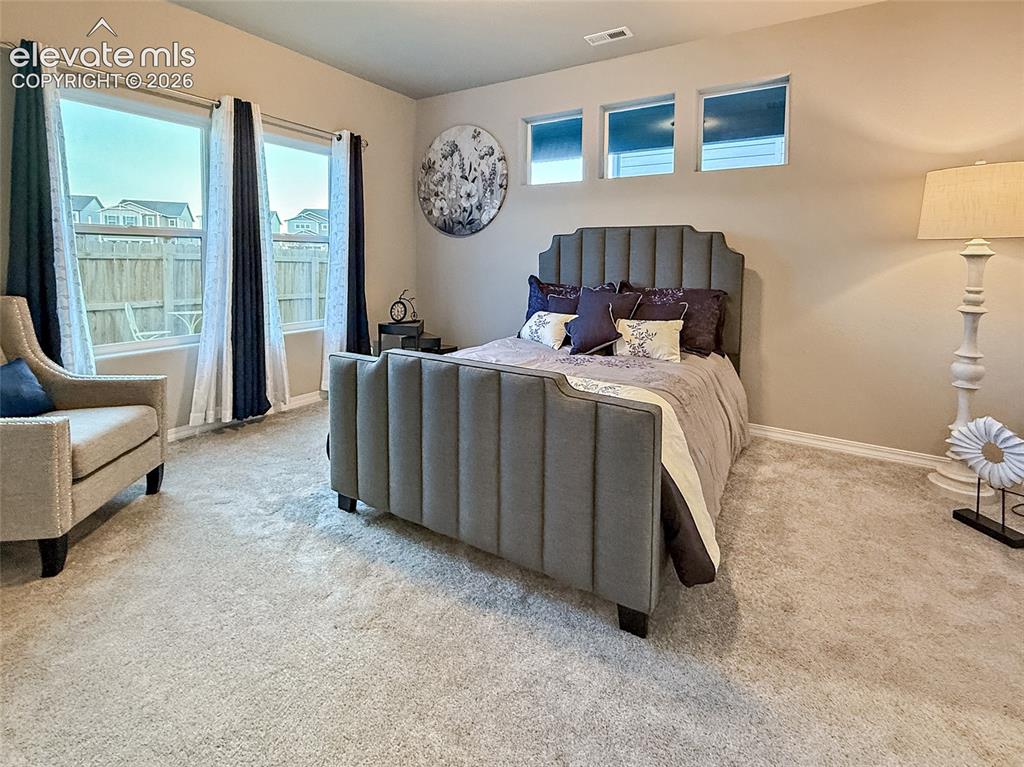 Image 7 of 24: Neutral-toned walls complement the carpeted flooring