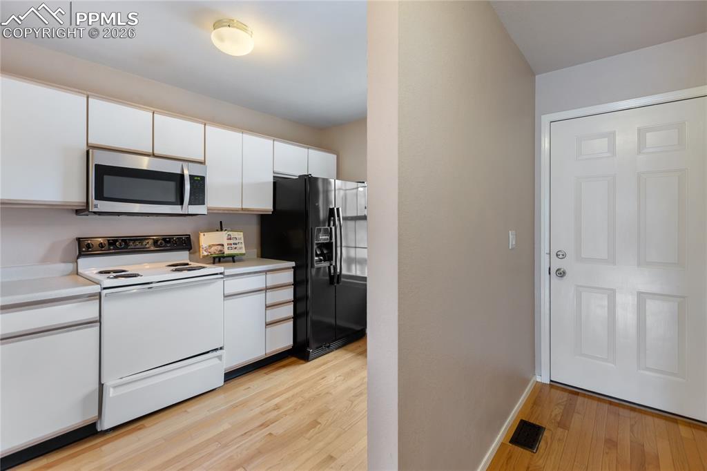 Image 16 of 37: The kitchen features includes all appliances, including a built-in microwav