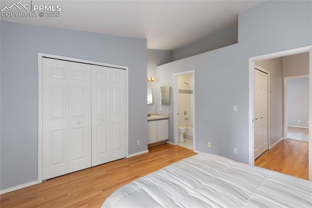 Image 23 of 37: Primary bedroom on the upper level features vaulted ceiling, full bathroom 