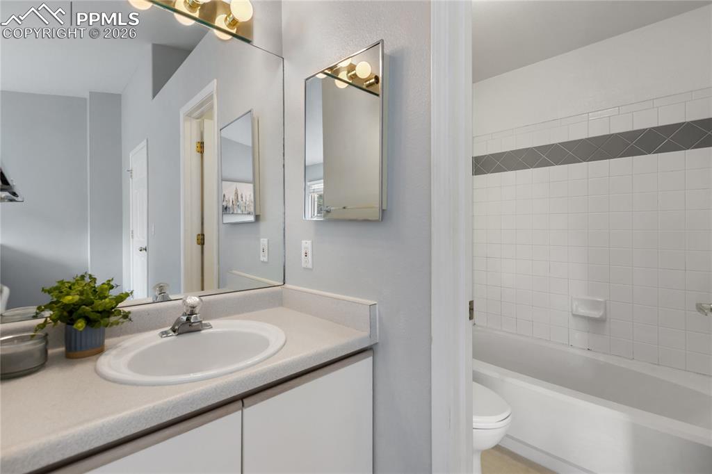 Image 25 of 37: Primary bathroom features separate access to the sink