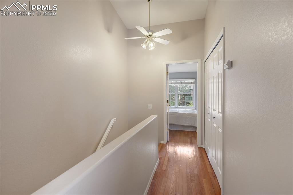 Image 27 of 37: Upper hallway features hard wood flooring