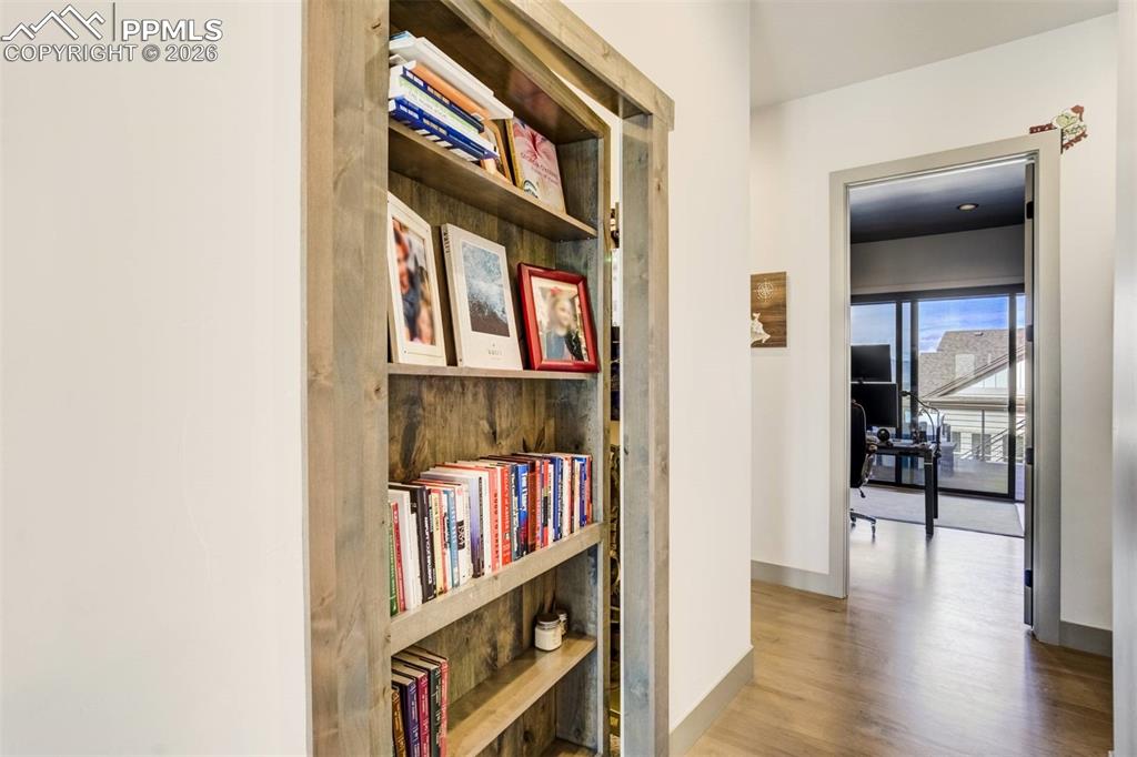 Image 26 of 50: Secret Vault Room Behind Bookshelf