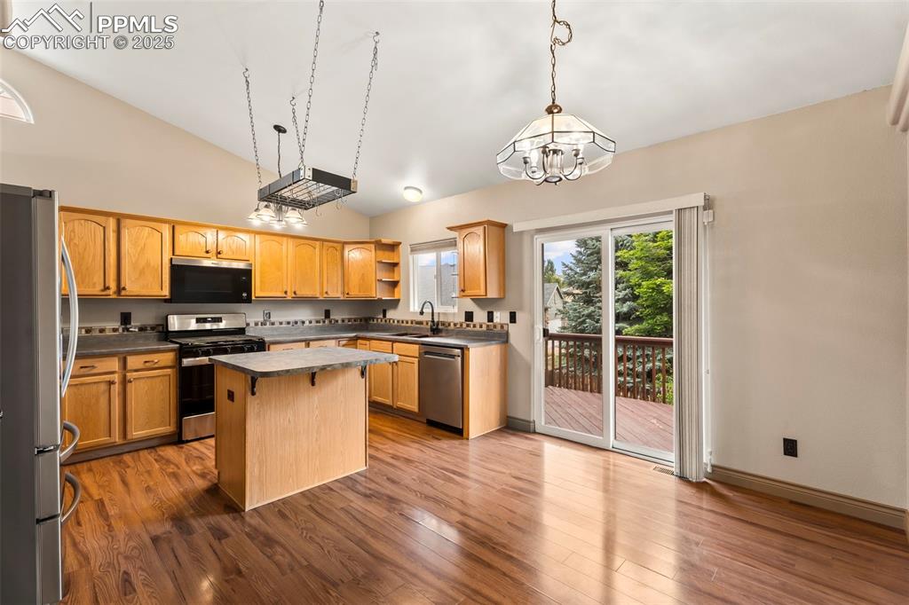 Image 10 of 34: Dining area and kitchen combo with walk out to deck. 