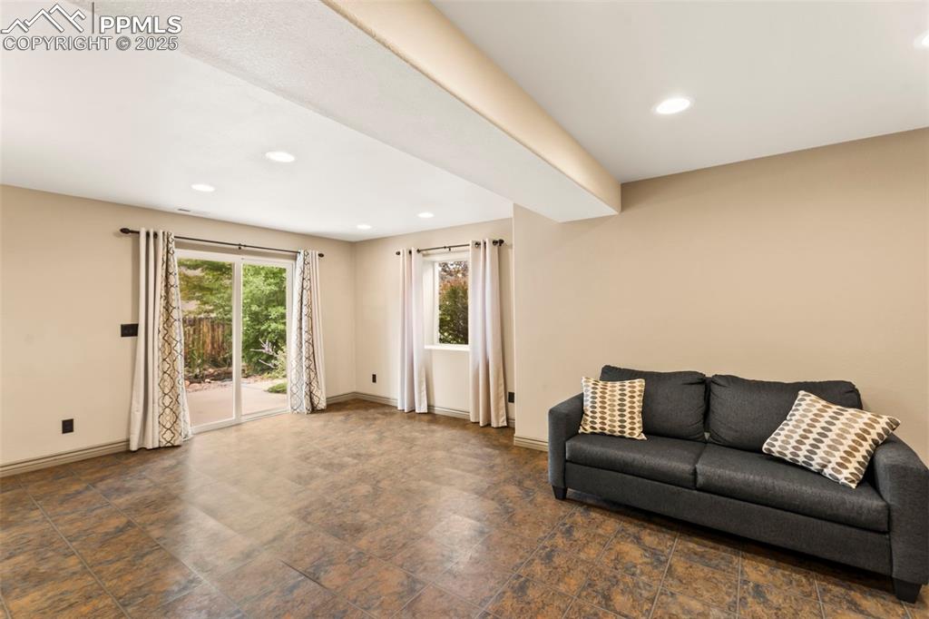 Image 21 of 34: Family room in basement with walk-out to backyard. 