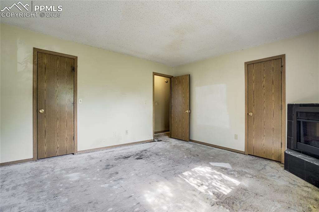 Image 11 of 24: Unfurnished bedroom featuring a textured ceiling and heating unit