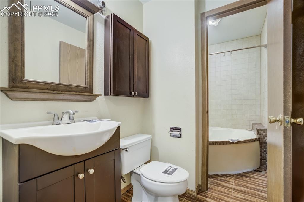 Image 15 of 24: Bathroom with vanity and shower / washtub combination
