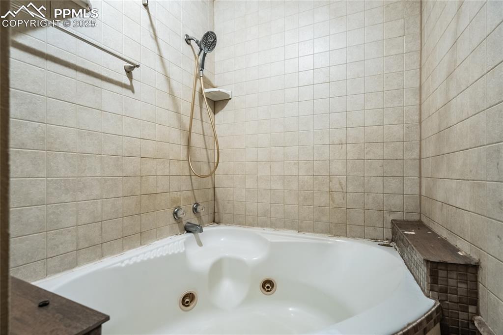 Image 16 of 24: Bathroom with tile walls