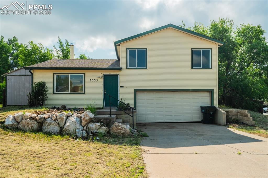 Image 24 of 24: Split level home with a garage and driveway