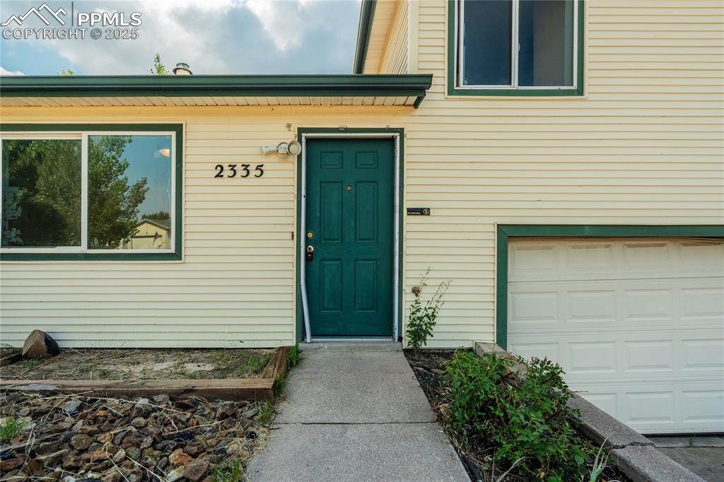 Image 3 of 24: Entrance to property featuring a garage