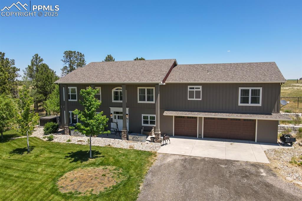 Image 2 of 50: View of front of house featuring an oversized 3 car attached garage