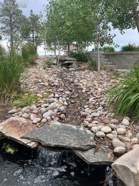 Image 38 of 50: Side patio with water feature