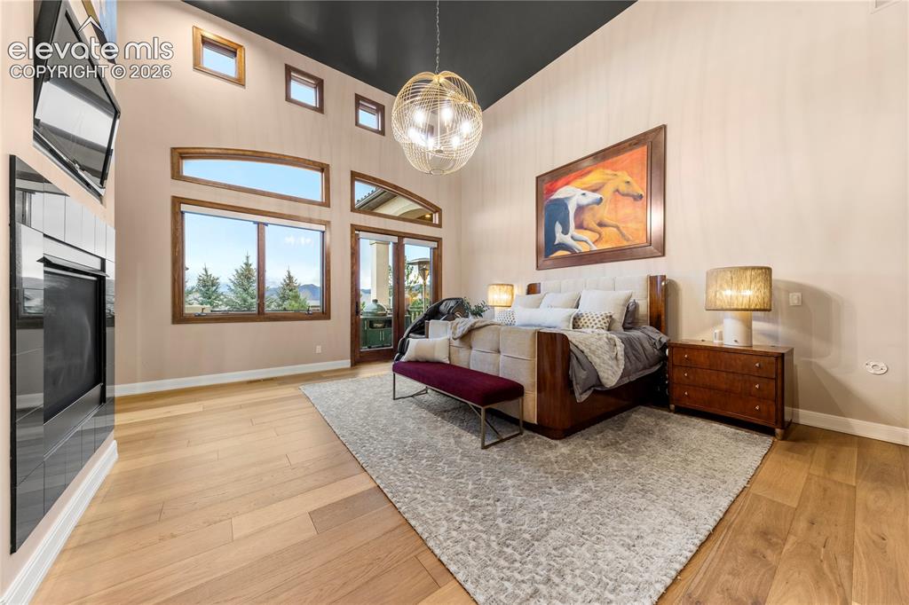 Image 23 of 36: Primary Bedroom with gas fireplace
