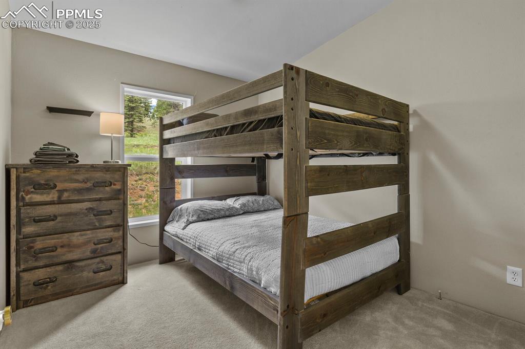 Image 21 of 37: Bedroom with light colored carpet