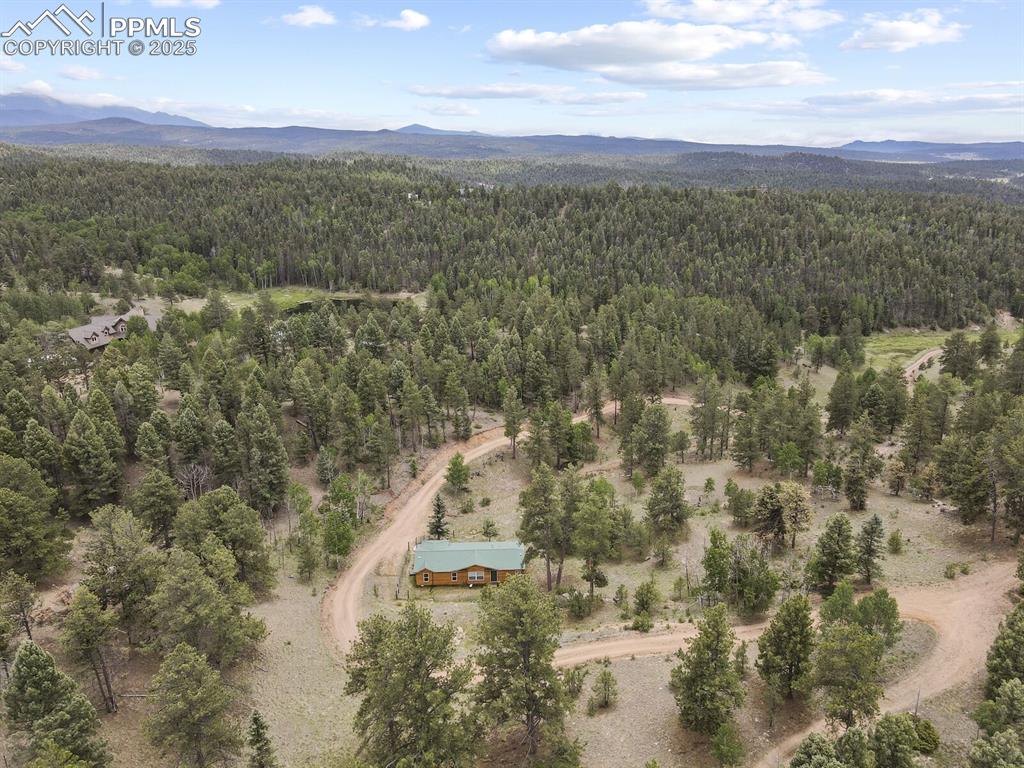 Image 35 of 37: Aerial view of mountains and a heavily wooded area