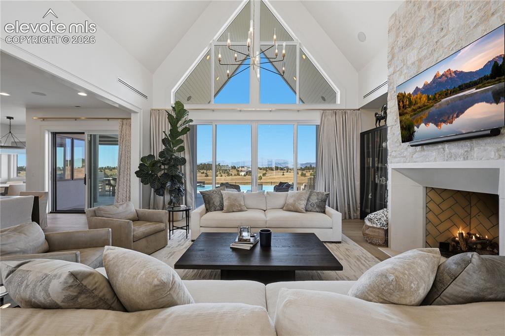 Image 12 of 50: Vaulted ceiling with floor-to-ceiling geometric windows, floor-to-ceiling s