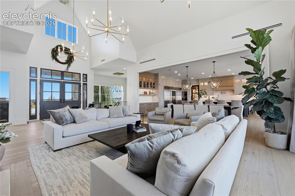 Image 14 of 50: Vaulted ceilings, expansive multi-pane windows, wood-finish flooring, custo