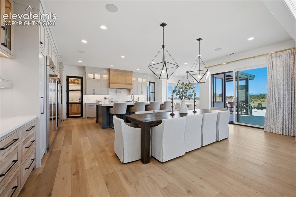 Image 15 of 50: Open-concept kitchen featuring an expansive center island, custom built-in