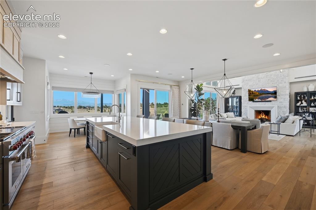 Image 18 of 50: Gourmet kitchen featuring a large central island with quartz countertops, c