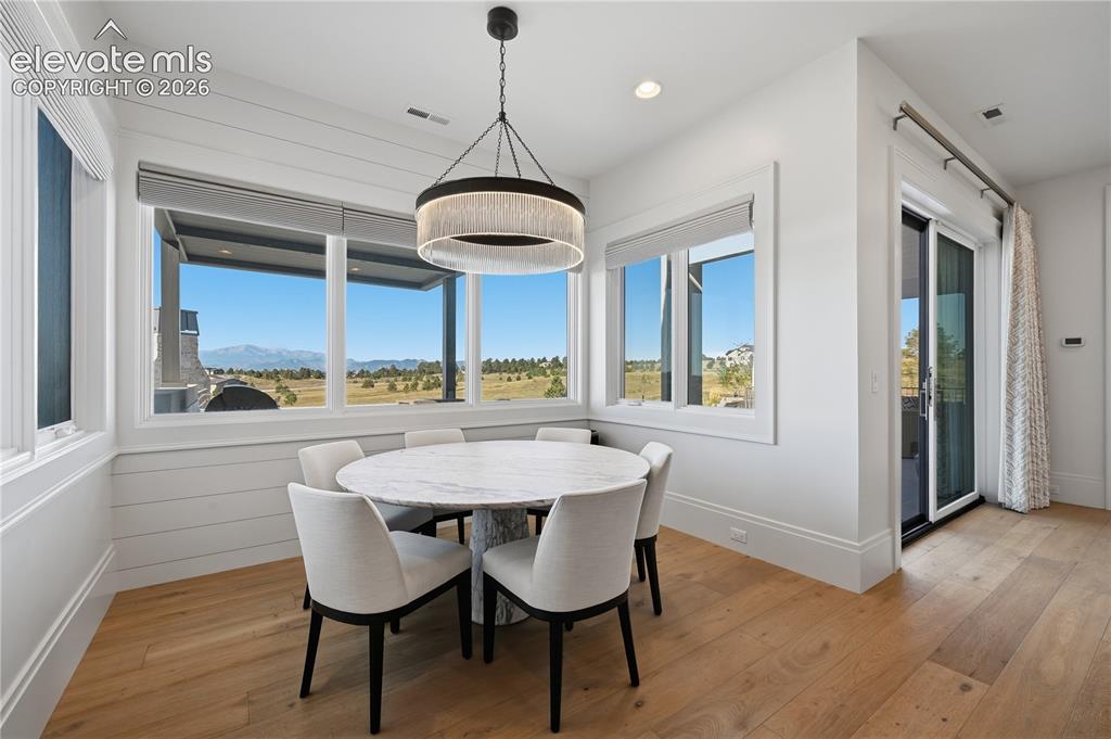 Image 19 of 50: Horizontal shiplap wall paneling, wood-finish flooring, large picture windo
