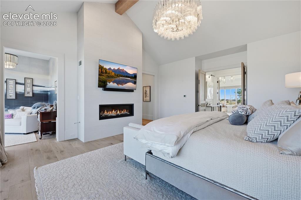 Image 24 of 50: Vaulted ceilings with exposed timber beams, linear gas fireplace with full-