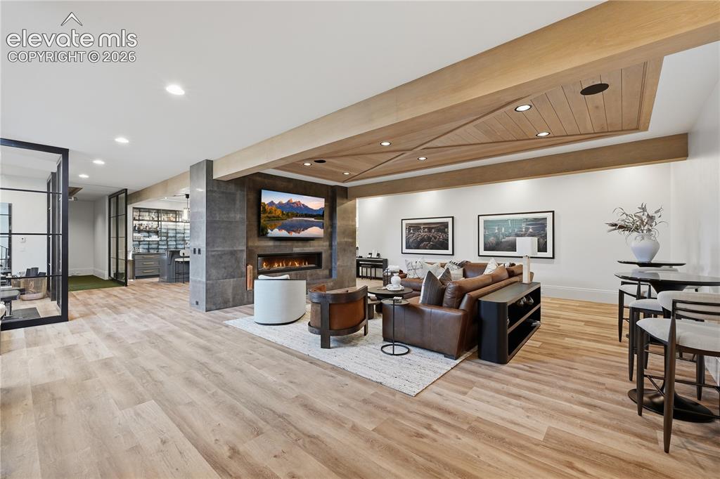 Image 30 of 50: Wood-finish flooring, custom wood-paneled ceiling inlay with recessed light