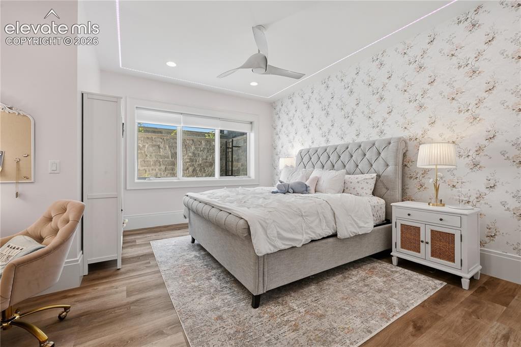 Image 38 of 50: Wood-finish flooring, tray ceiling with recessed lighting, central ceiling 