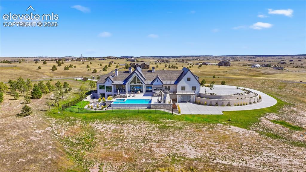 Image 9 of 50: Custom residence featuring multi-gabled rooflines, stone and siding exterio