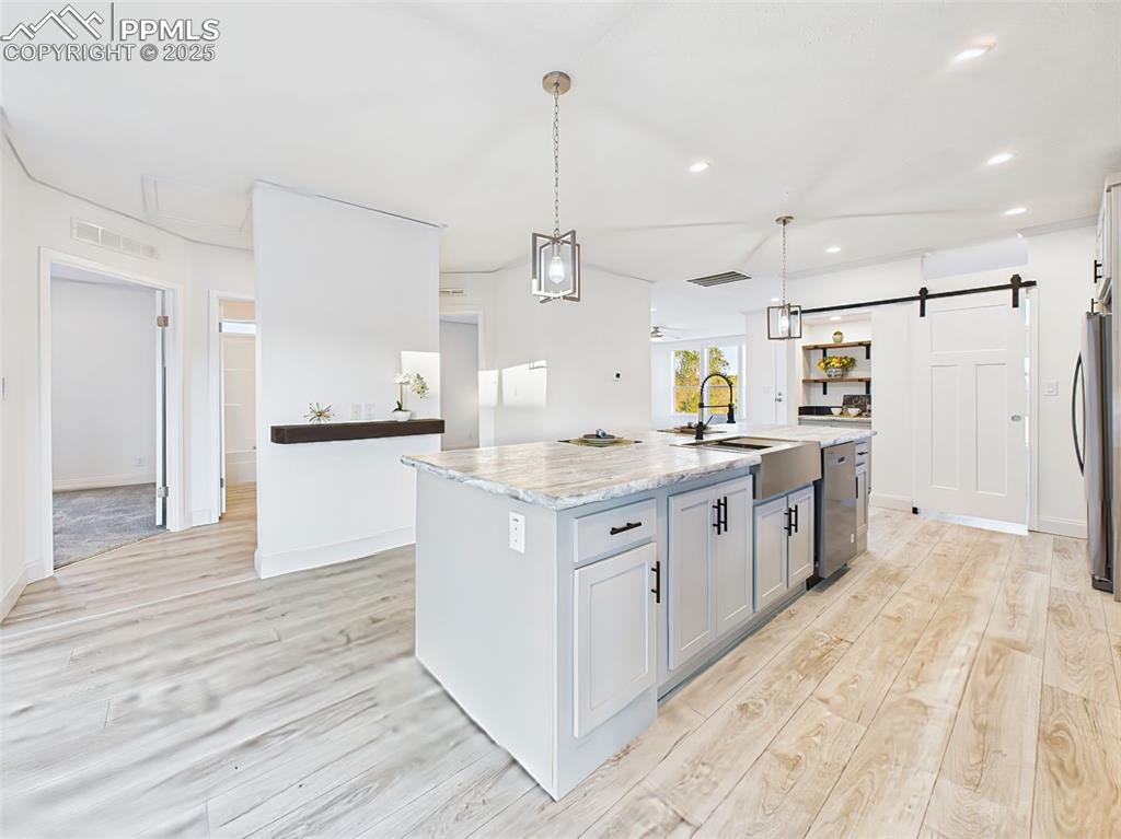 Image 17 of 50: View from the island showcasing open flow into the Bedroom hall and abundan