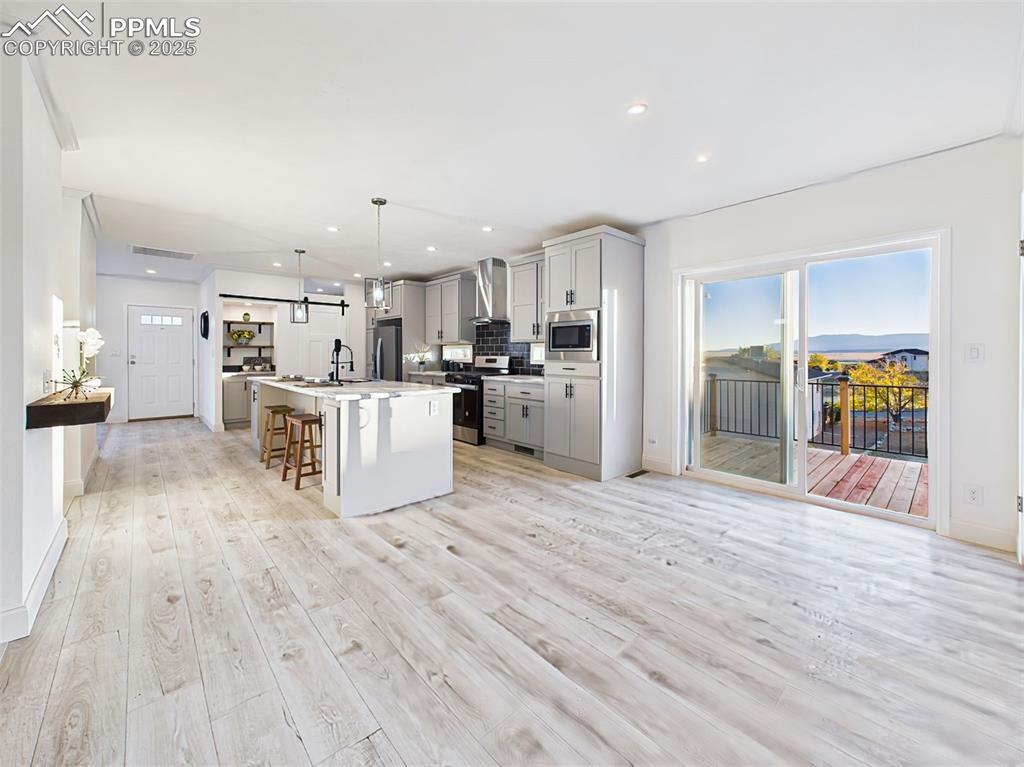 Image 21 of 50: Bright and open dining area with sliding glass doors leading to outdoor liv
