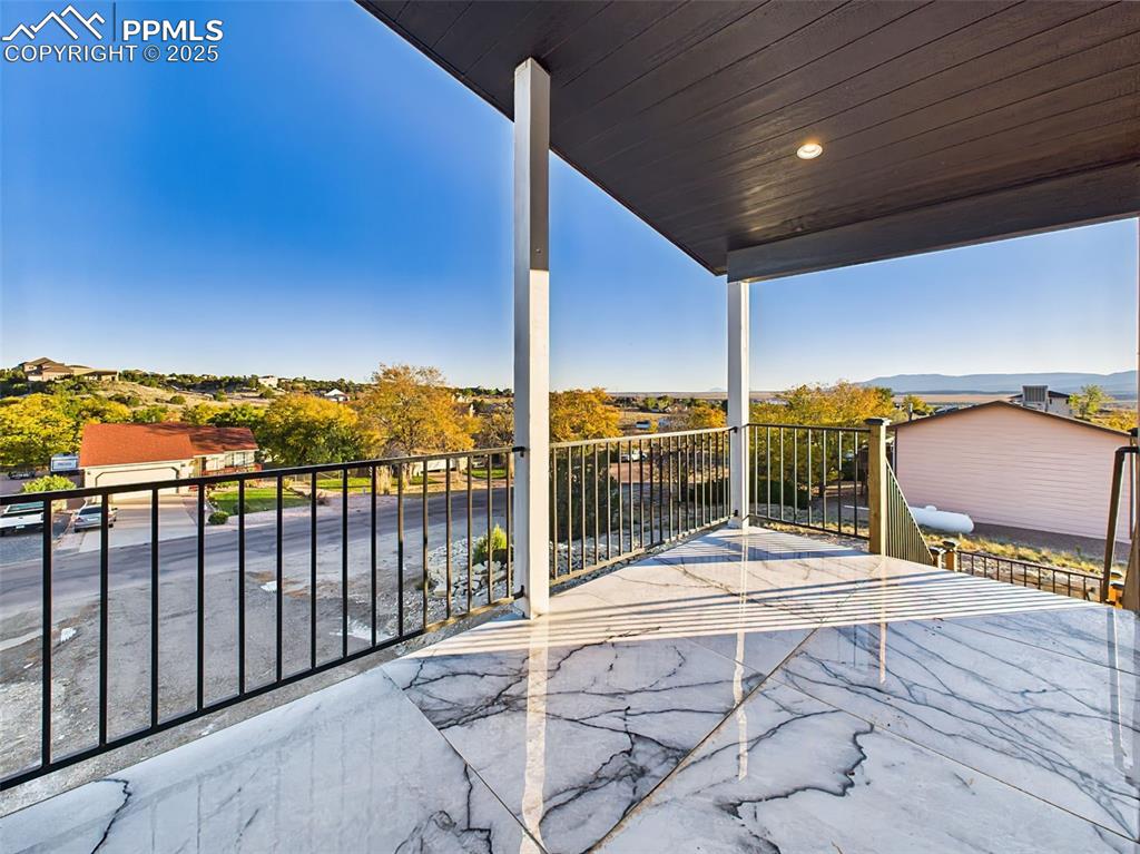 Image 3 of 50: Spacious covered deck featuring stylish tile flooring and stunning panorami