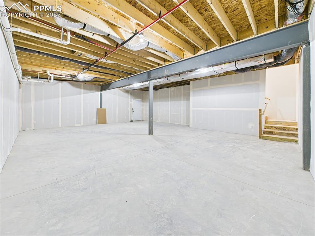 Image 40 of 50: Expansive basement ready for customization—framed, insulated, and plumbed f