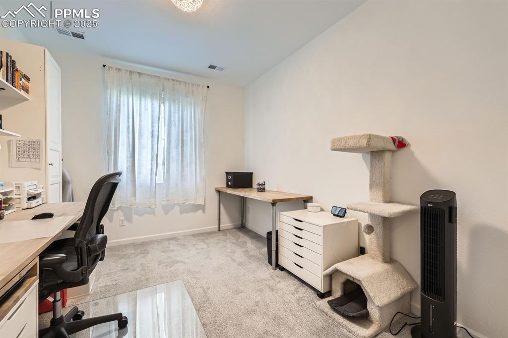 Image 14 of 28: Office space featuring light carpet and baseboards