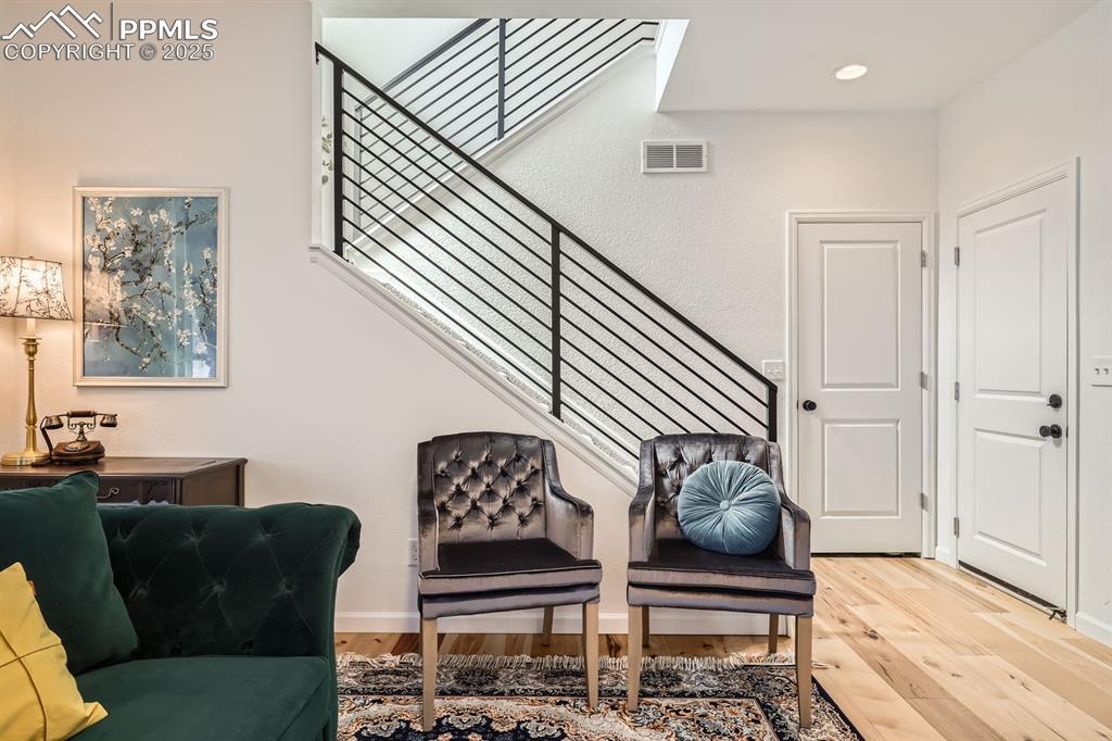 Image 17 of 28: Sitting room featuring wood finished floors and stairway