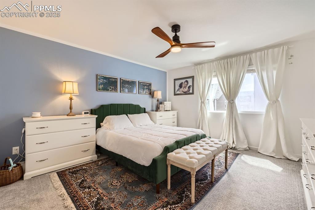 Image 19 of 28: Carpeted bedroom featuring a ceiling fan